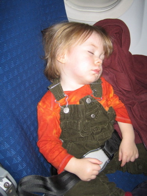 Erika sleeping on an airplane