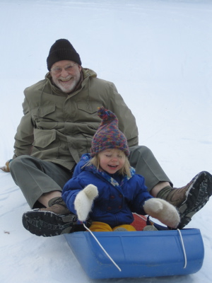 Erika and Grandpa together on sled