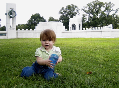 Erika sitting on the grass in front of the World War II memorial