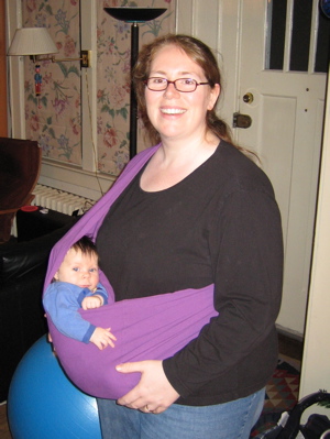 Sonja carrying Erika in a purple sling