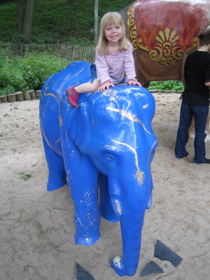 Erika sitting on an elephant statue