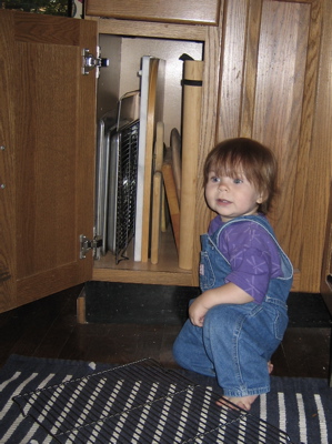 Erika kneeling in front of a cabinet