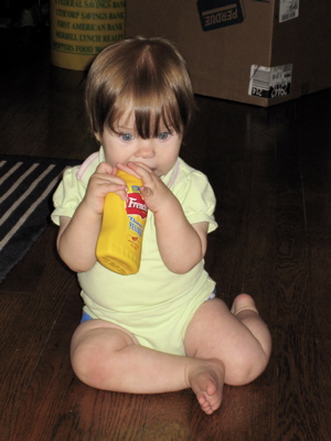 Erika chewing on a mustard bottle